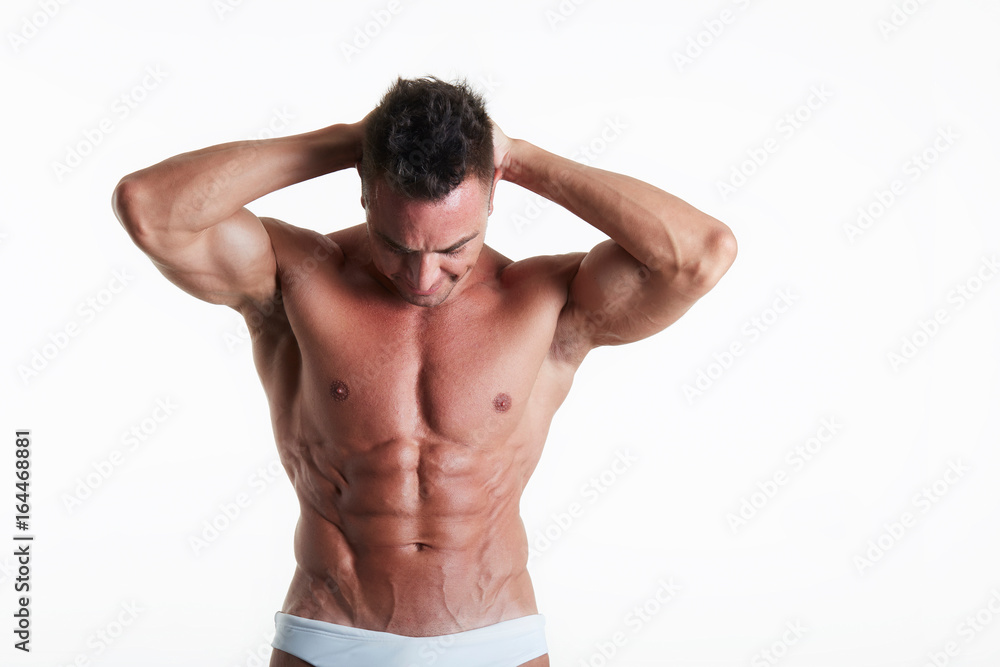 Handsome muscular fit young man on studio background Handsome muscular fit young man on studio background