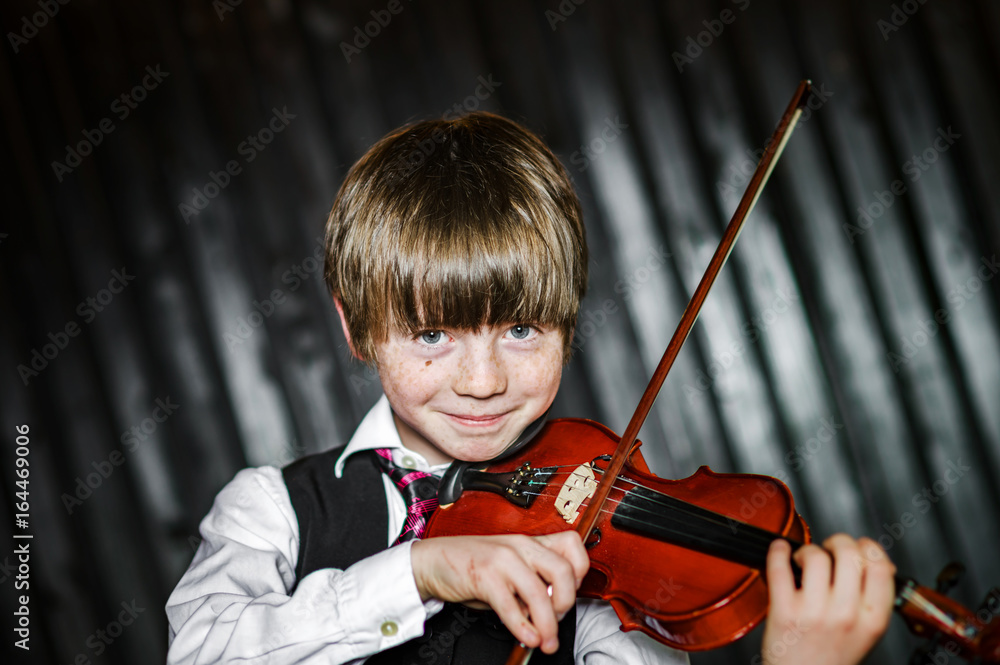 Attractive boy playing violin, shooting Stock Photo | Stock