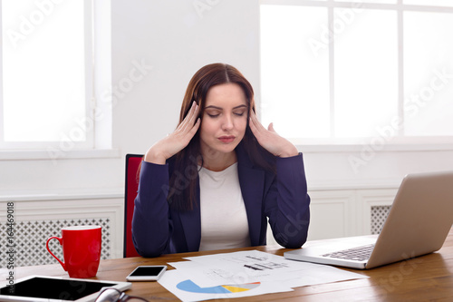 Frustrated business woman with headache at office © Prostock-studio