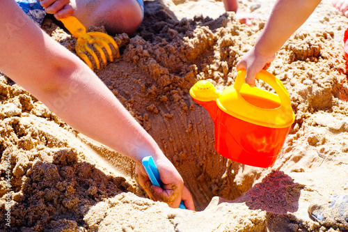 childs are playing game at the beach, close up