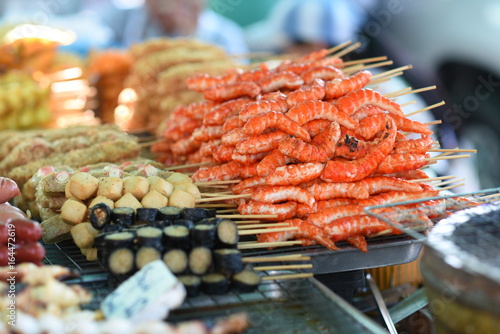 Food street in Thailand, meat grilled on a sticks.