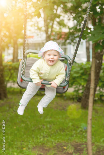 The baby is swinging on the swing © zhekkka