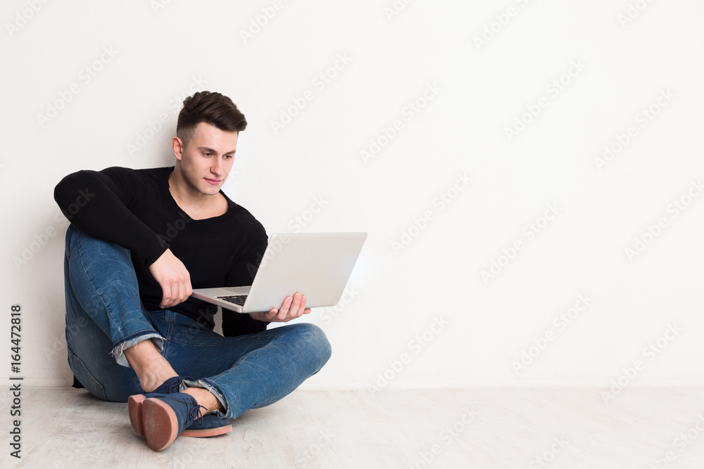 Young man freelancer in casual with laptop Young man freelancer in casual with laptop