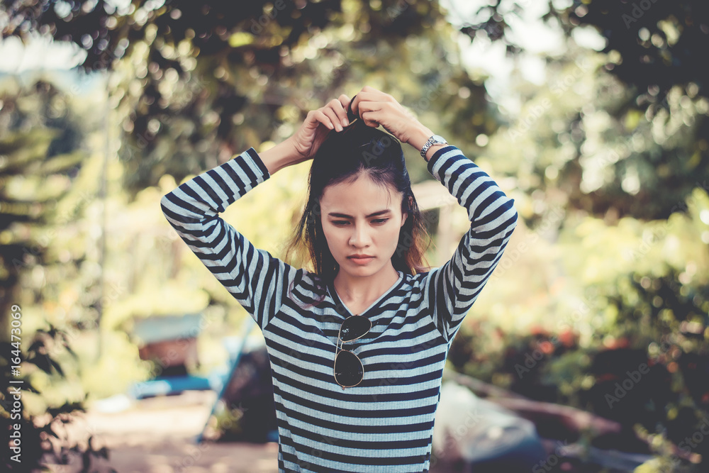 Woman Hipster with sunglasses Fashion Style Lifestyle Concept, wearing a black and white striped t-shirt.