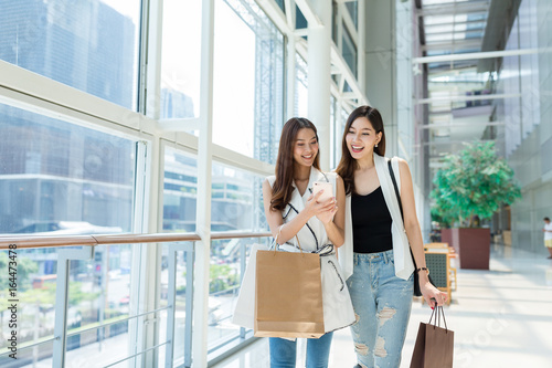 Photography Friends go shopping and using cellphone together
