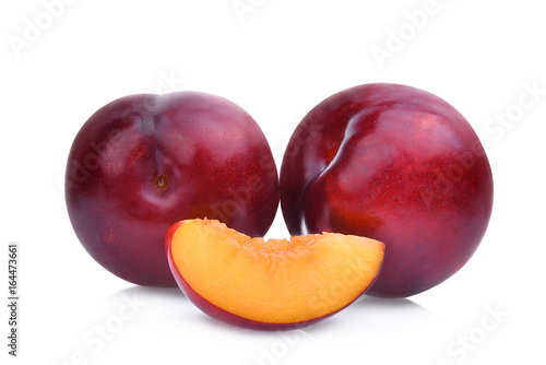two whole and slice of red cherry plums isolated on white background