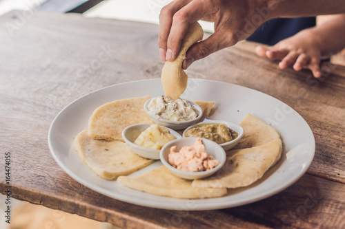 Pieces of pita bread and four kinds of Greek sauces. Greek food concept photo