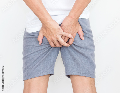 Young man has pain in the butt, Hemorrhoids, Anal disorders.