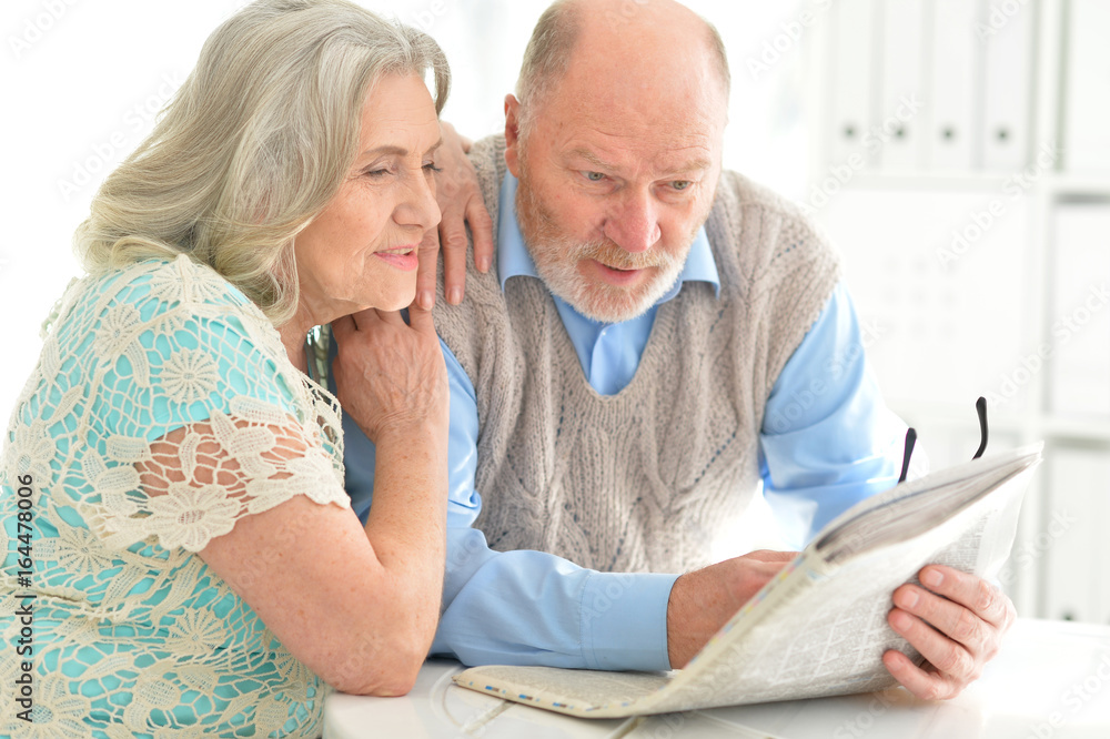 senior couples reading newspaper senior couples reading newspaper