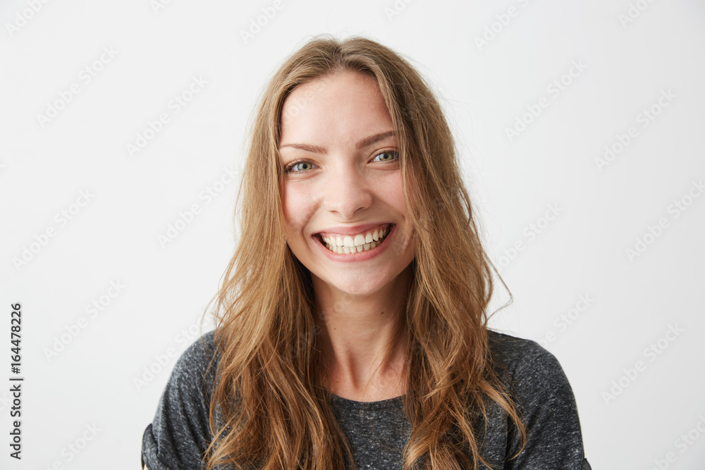 Young cheerful happy girl smiling laughing looking at camera over white background. Young cheerful happy girl smiling laughing looking at camera over white background.