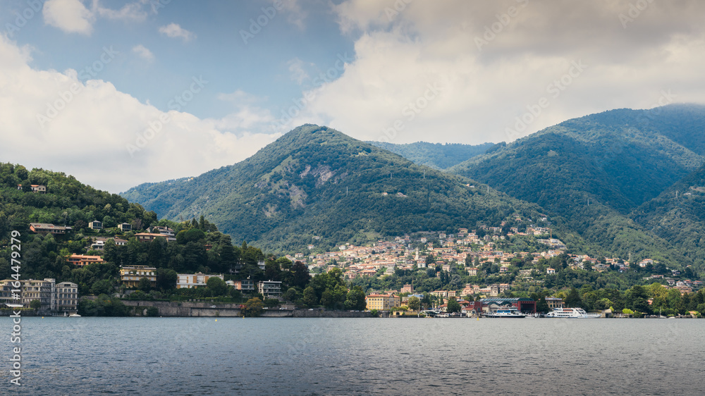 Como lake with houses and yatch seen from Lungolario or lungo lago promenade Italy