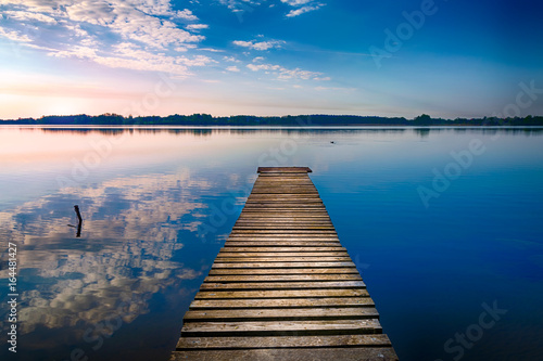 Fototapeta Naklejka Na Ścianę i Meble -  Empty footbridge over the lake Selment Wielki. Masuria, Poland.