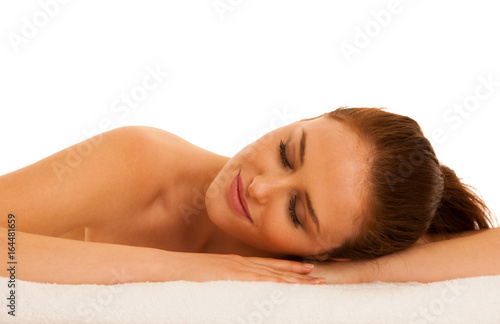 woman rests on white towel - conceptual photo for skin care and spa