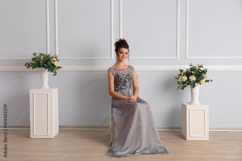 Gorgeous woman in transparent dress sits on chair Gorgeous woman in transparent dress sits on chair
