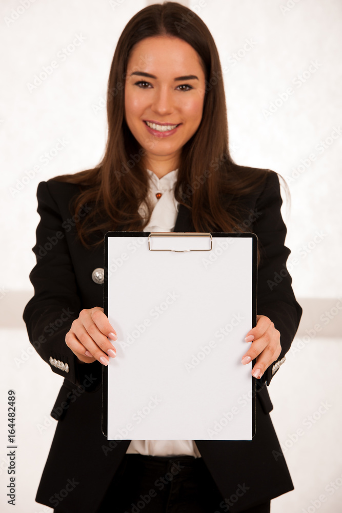 Asian caucasian busines woman writing on a clipboard Asian caucasian busines woman writing on a clipboard