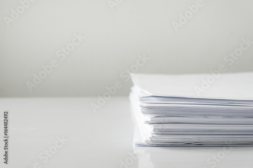 blank papers on white table,blank stack documents paper on office desk.