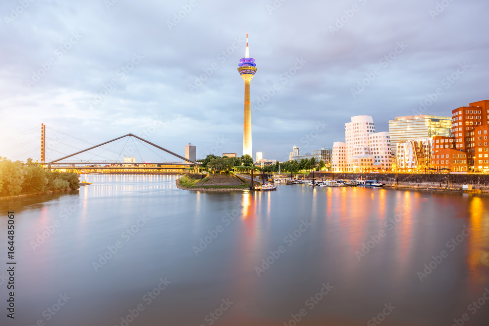 Night view on the Rhein river with illuminated buildings and television tower in Dusseldorf city, Germany