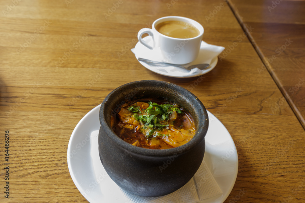 Traditional Georgian soup Kharcho with meat and rice on wooden background Traditional Georgian soup Kharcho with meat and rice on wooden background