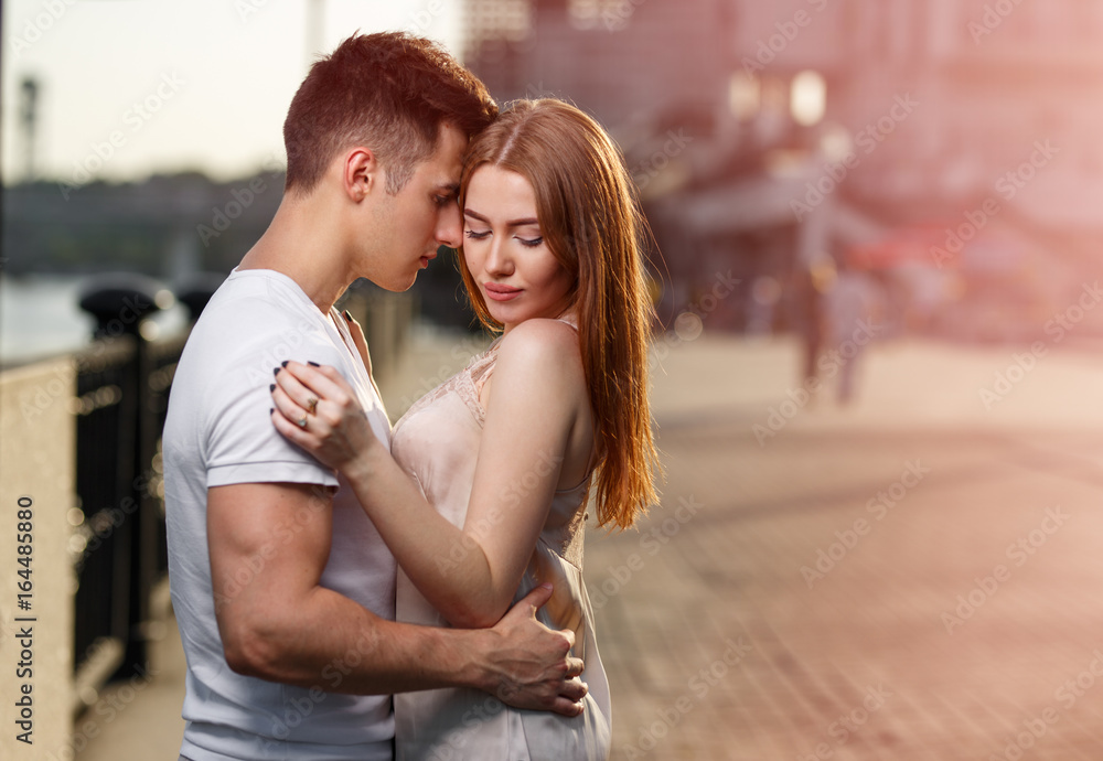Portrait of young couple in love, enjoying the sunset in city Portrait of young couple in love, enjoying the sunset in city