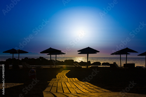 Wooden pavement on the beach at sunset time © luchschenF