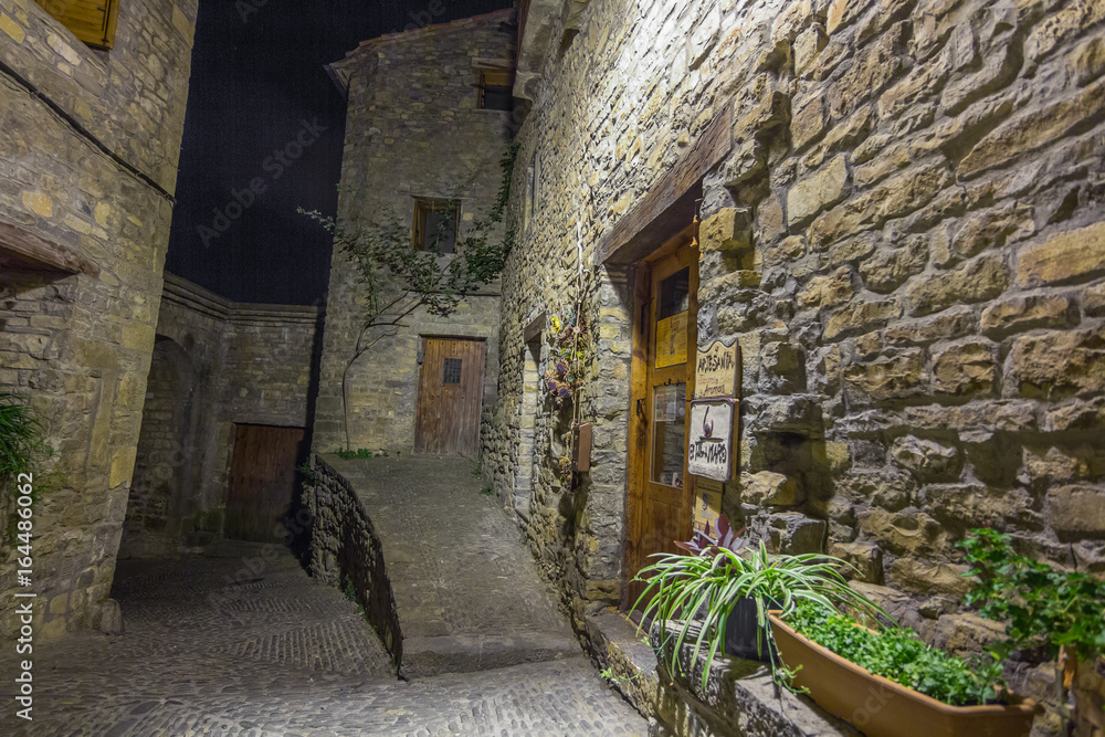 Ainsa medieval village of the Pyrenees with beautiful stone houses at night, Huesca, Spain