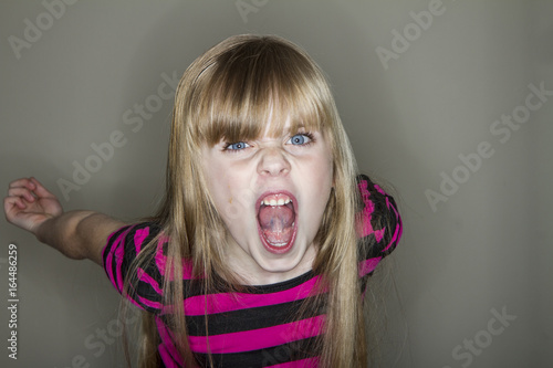 Fotografie Young girl screaming at the camera