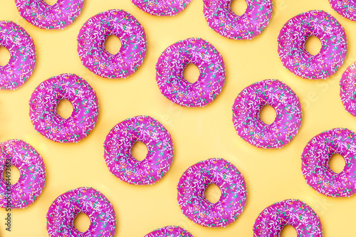 isometric. Pink donut pattern on a yellow background