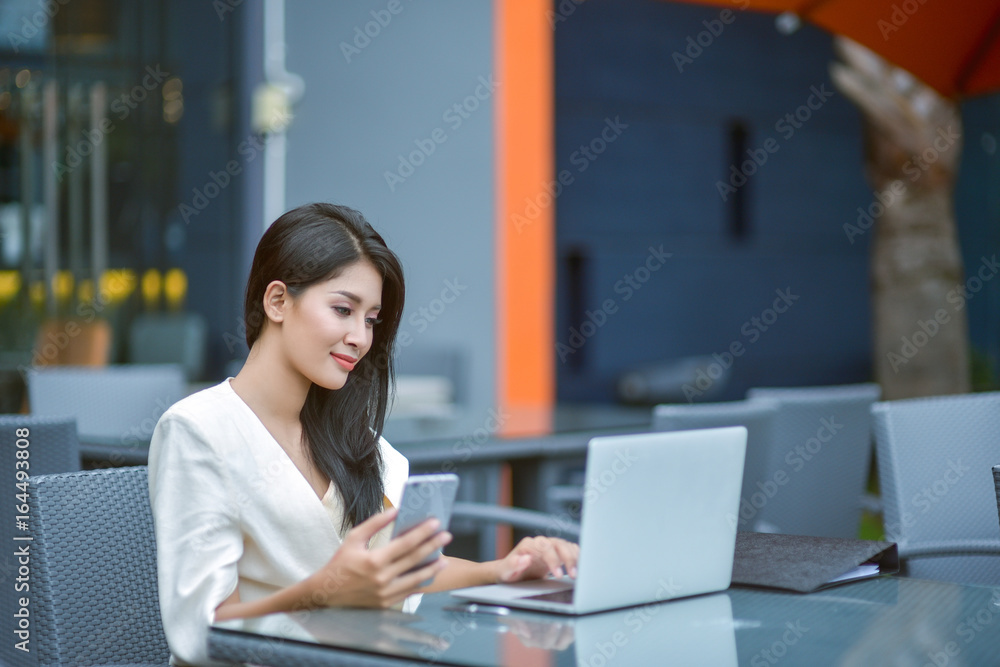 Young woman sitting in a cafe with her laptop, Stressful for work. Young woman sitting in a cafe with her laptop, Stressful for work.