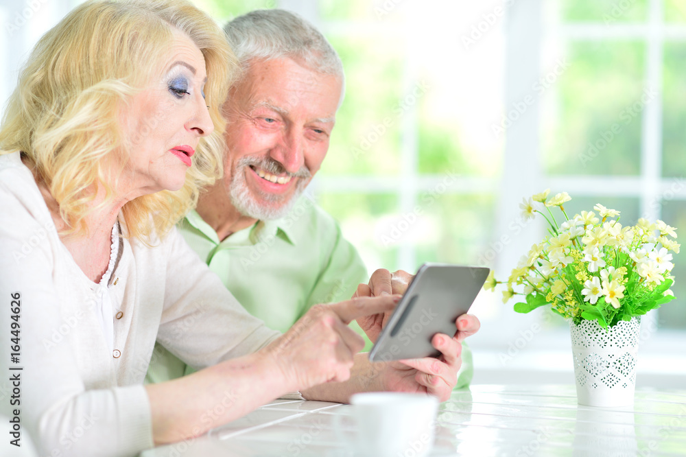 senior couple using tablet senior couple using tablet