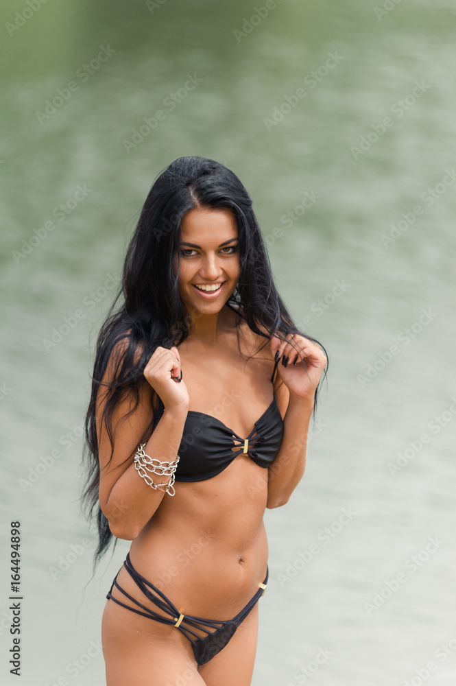 Beautiful girl posing and laughing at the beach Beautiful girl posing and laughing at the beach