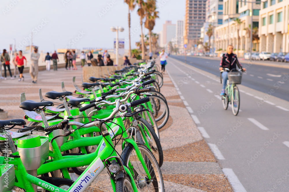TEL AVIV, ISRAEL- APRIL, 2017: Parked bicycles in center of Tel Aviv.Blurred view of the embankment of Tel Aviv and bike roads.