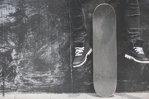Fototapeta Legs in sneakers at the skateboard