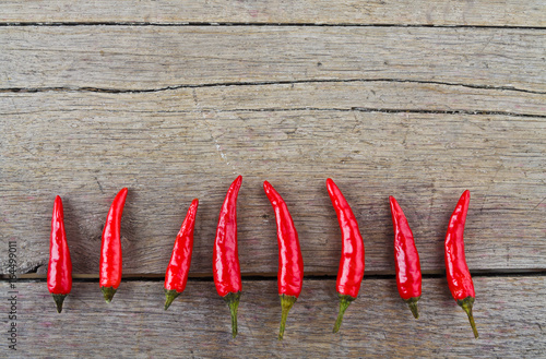 Red hot chili peppers on wooden table