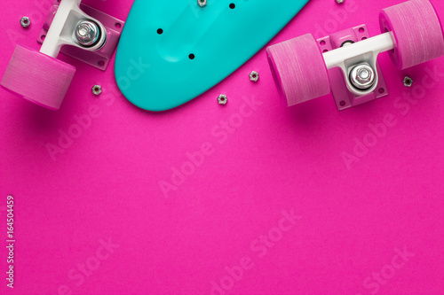 Fotografie plastic mini cruiser board disassembled on deep pink with background copy space