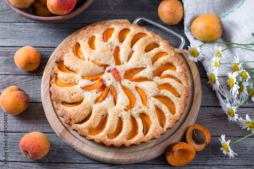 Apricot pie with fresh fruits on wooden table photo