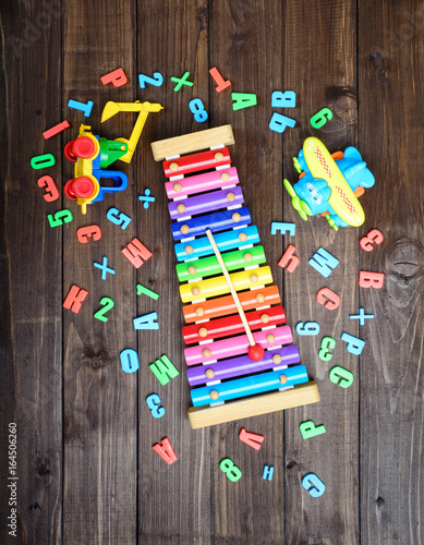 boys toys and colord letters on wooden table. top view. photo