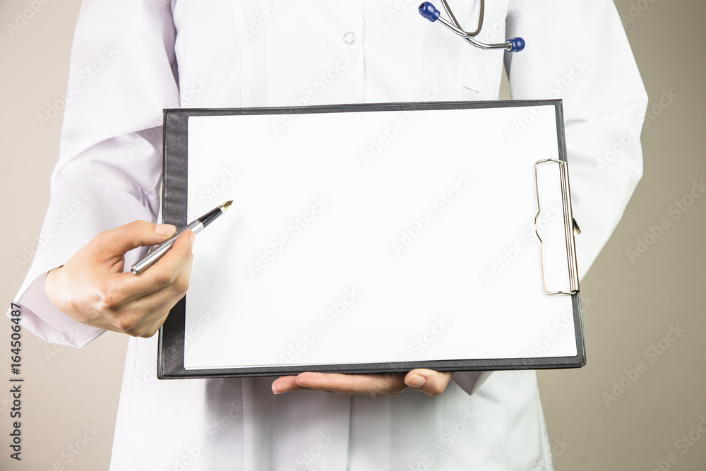 doctor's hands with a plane-table shows pen. Healthcare and medical concept Showing blank paper by hand with woman doctor doctor's hands with a plane-table shows pen. Healthcare and medical concept Showing blank paper by hand with woman doctor