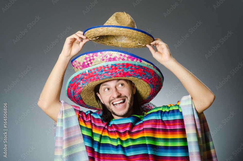 Man in a vivid mexican poncho gray background isolated Man in a vivid mexican poncho gray background isolated