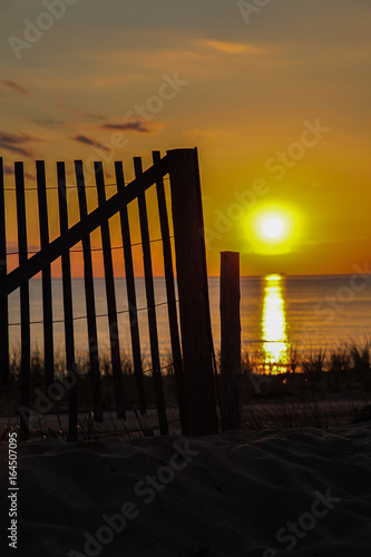 Wooden fence with sunset sky photo