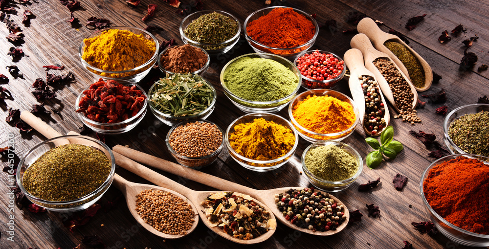 Variety of spices and herbs on kitchen table Variety of spices and herbs on kitchen table