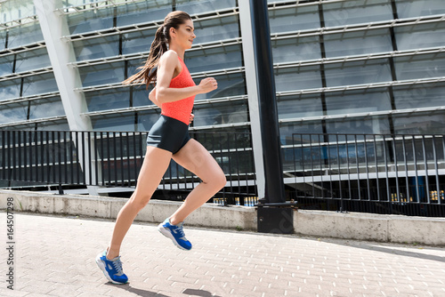 Joyful young woman running near stadium © Yakobchuk Olena