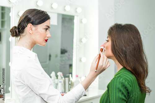 Woman applying cosmetic