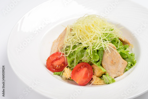 Caesar salad with chicken fillet. White background, menu concept.