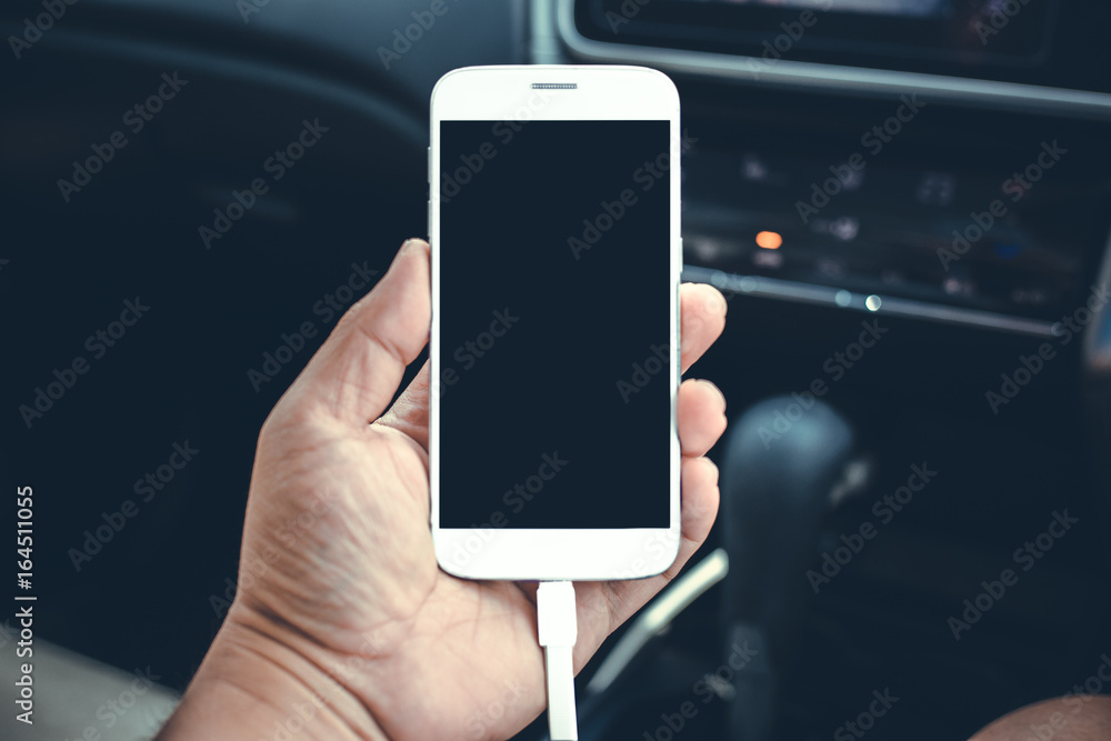 man sitting in the car and holding a touch phone with isolated screen man sitting in the car and holding a touch phone with isolated screen