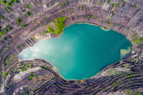 aerial view of deep mine lake in place of the mining pit