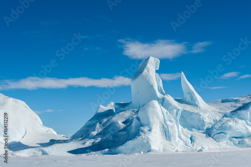 A jagged iceberg frozen into the sea ice in the Weddell Sea Antarctica.