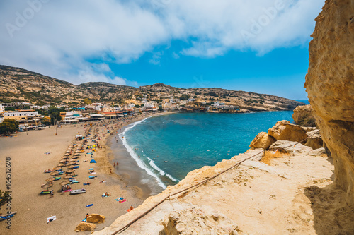 Panorama of Matala beach and caves on the rocks, Crete, Greece