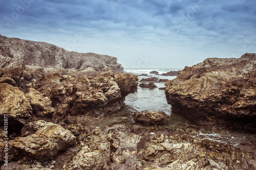 Rocks on the shore of the Pacific Ocean. © Grispb