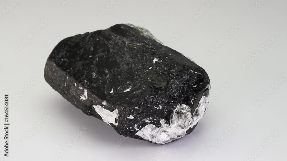 Tourmaline, black mineral stone isolated on a white background Tourmaline, black mineral stone isolated on a white background