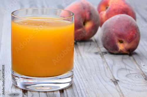 Peach juice in a glass on table
